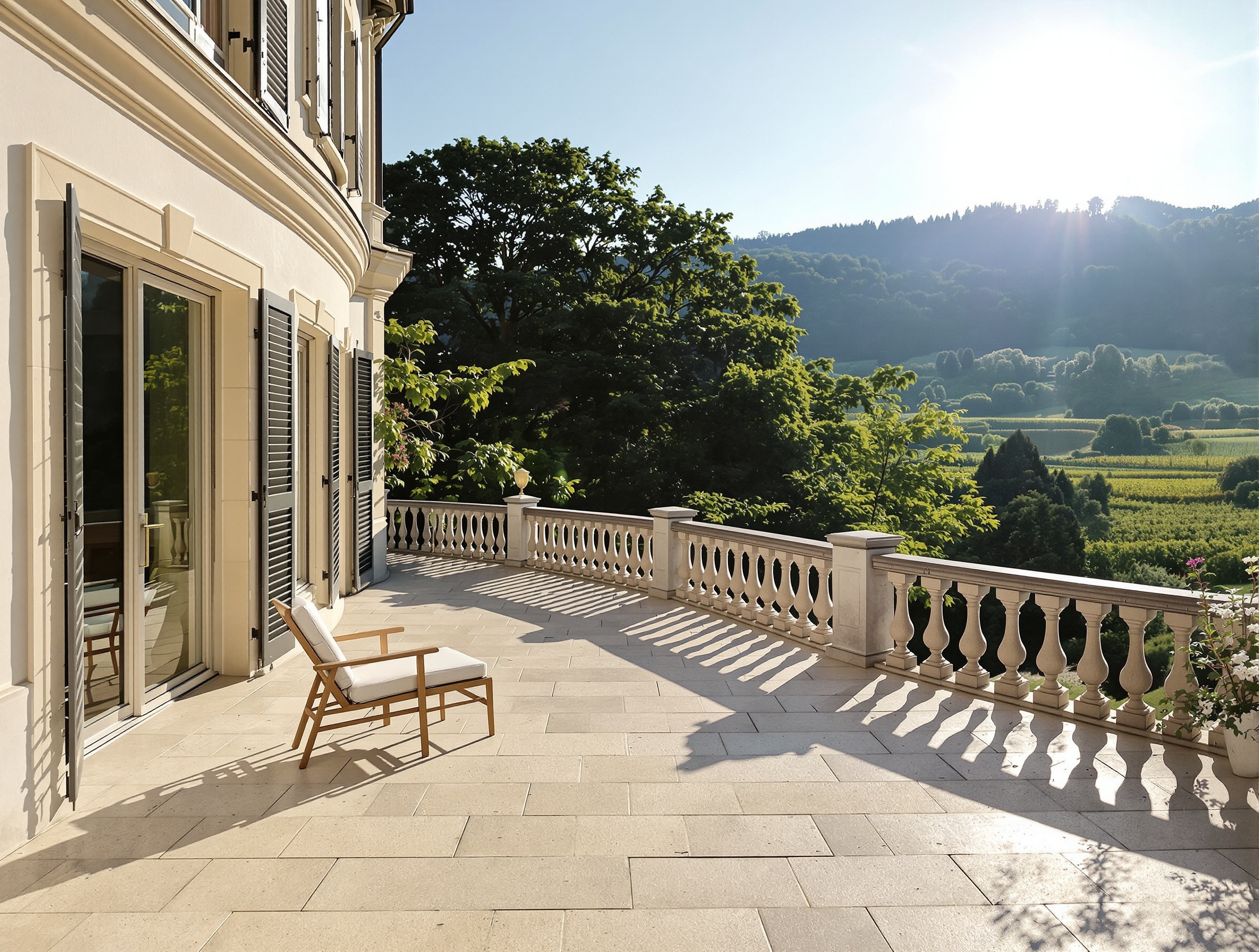 Terrasse ensoleillée d'une maison de maître avec vue sur les vignes, illustrant la complexité des limites de propriété sur les coteaux vaudois.
